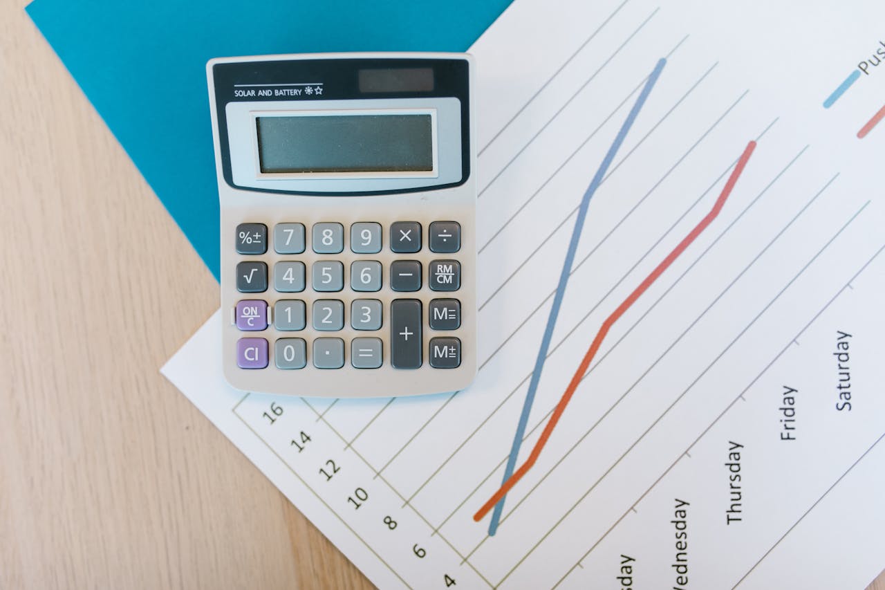 Services Top view of calculator and graph paper on office desk, perfect for business themed visuals.